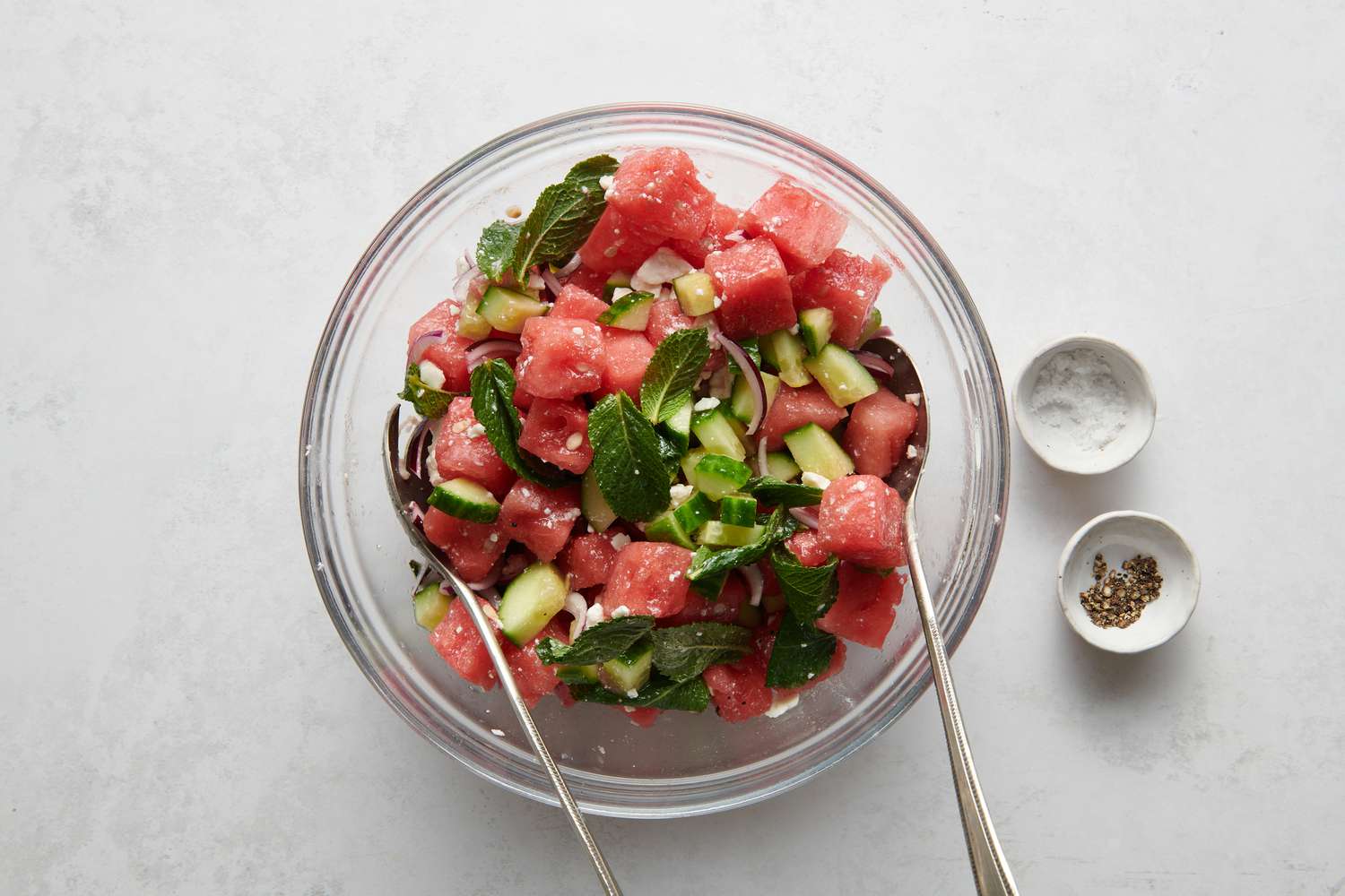 A bowl of watermelon salad with feta, mint, and cucumber