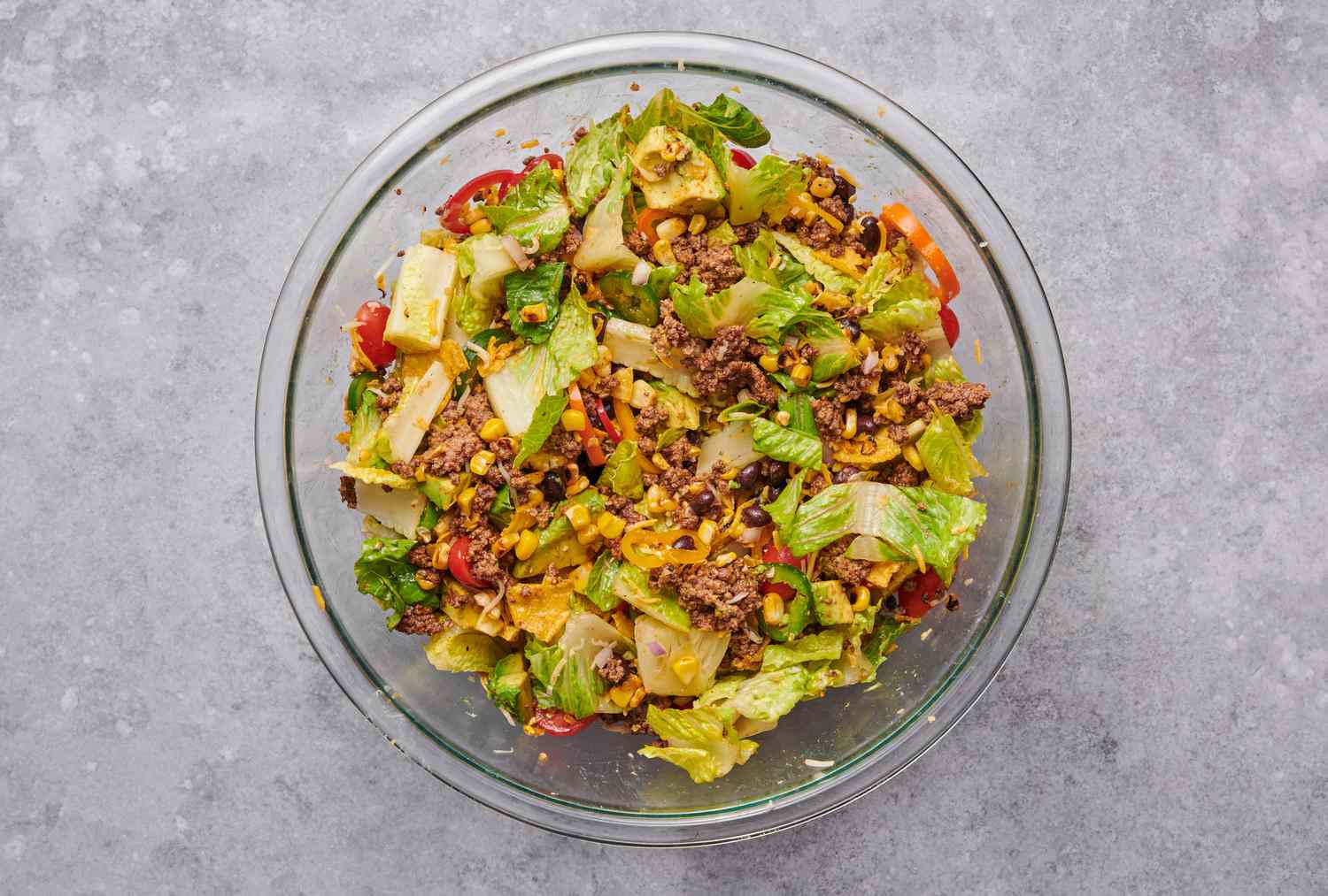 A large bowl of taco salad with cooked ground beef