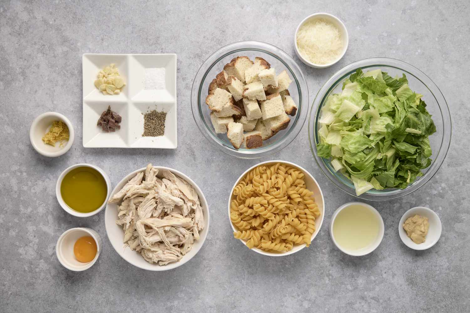 Ingredients to make chicken caesar pasta salad