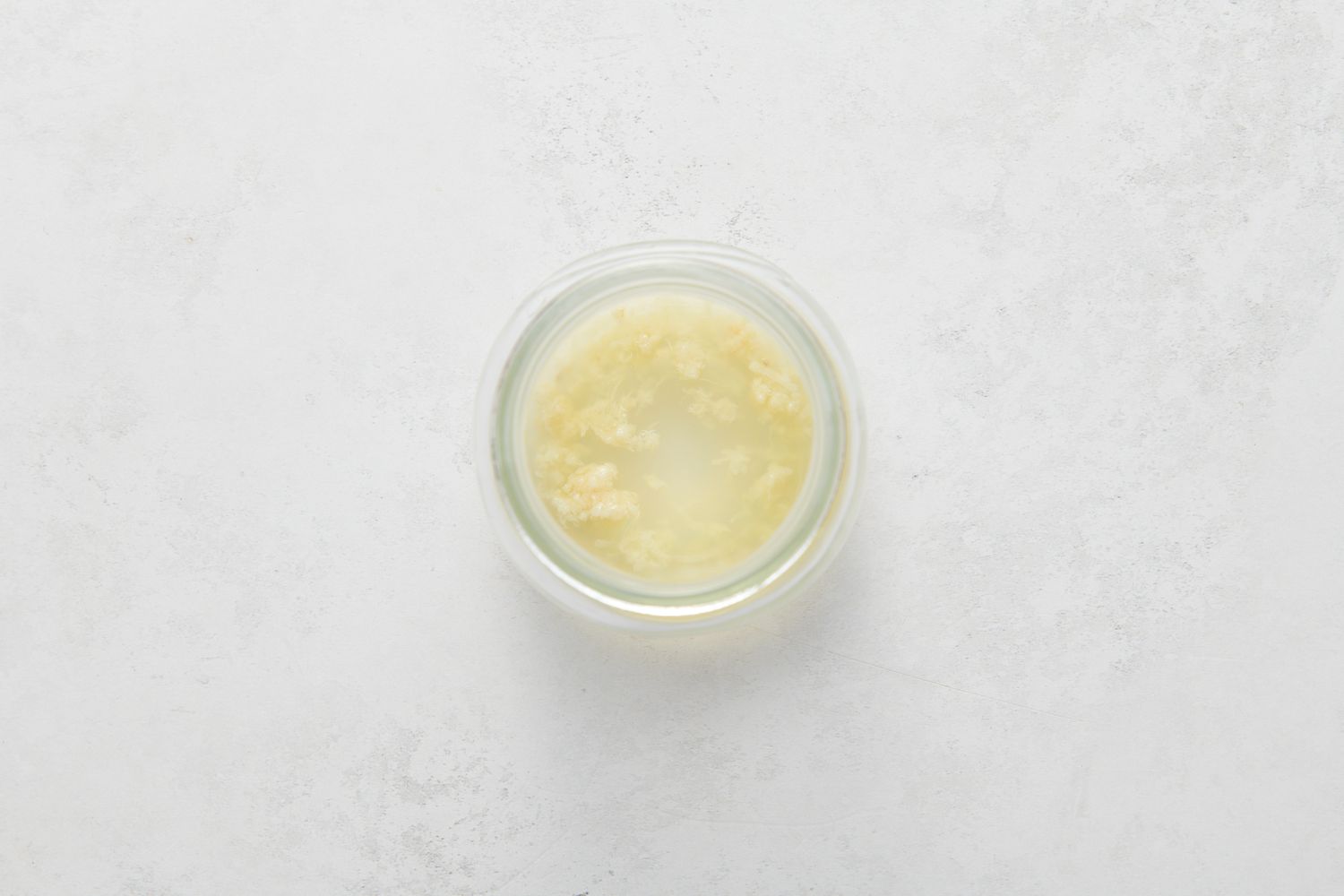 A jar with lemon juice and garlic